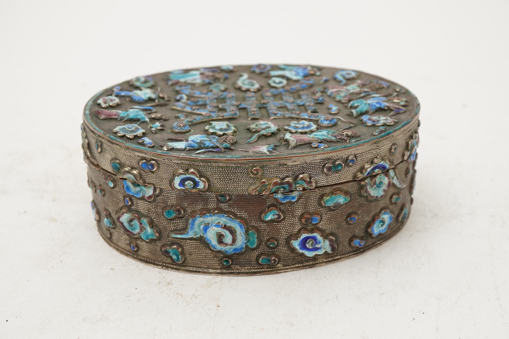 A Chinese silver plated and enamel ‘eight immortals’ oval box, late 19th century
